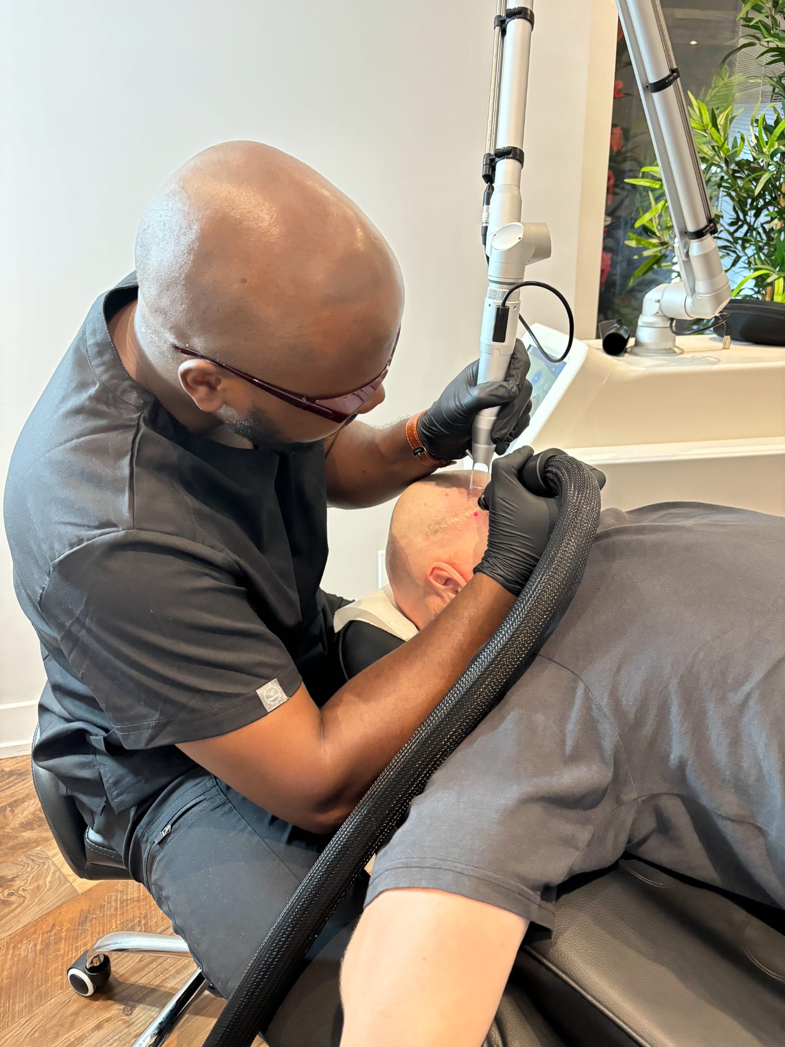 Close-up of laser tattoo removal being performed on a client's skin at Rico Clinic