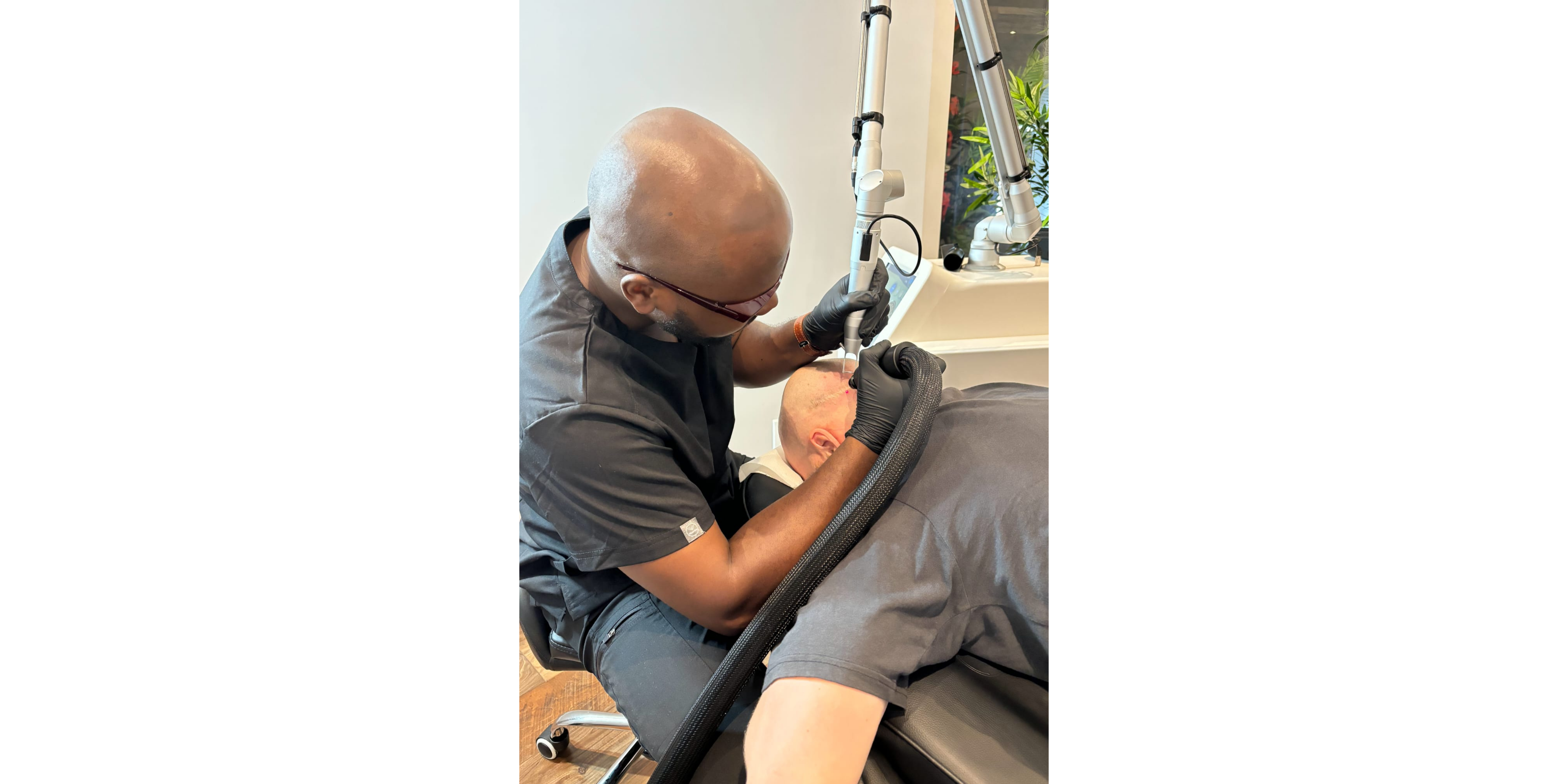 A Rico Clinic laser technician performing a tattoo removal treatment on a client's arm in Montreal